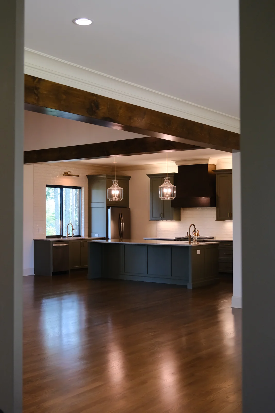 Kitchen with pendant lighting, natural daylight, and exposed wood beams